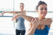 Two women stretching their arms