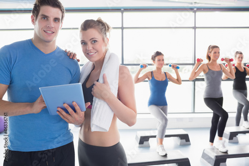 Photo: Trainer and woman smiling together during aerobics class Trainer and woman smiling together during aerobics class