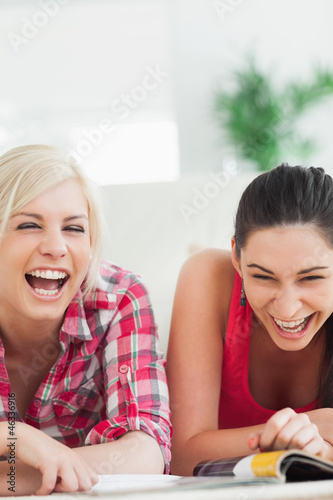 Photo: Women lying on the floor laughing Women lying on the floor laughing