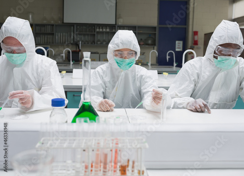Photo: Chemists working in protective suits Chemists working in protective suits