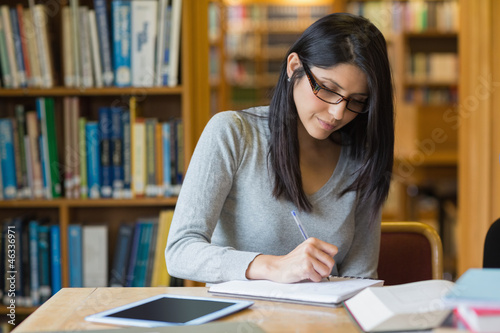 Photo: Woman studying in the library Woman studying in the library