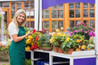 Garden center worker tending the flowers