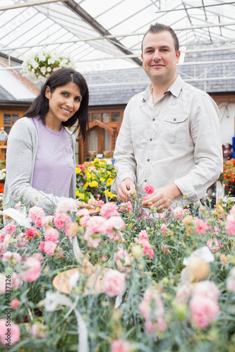 Photo: Smiling couple choosing flowers Smiling couple choosing flowers