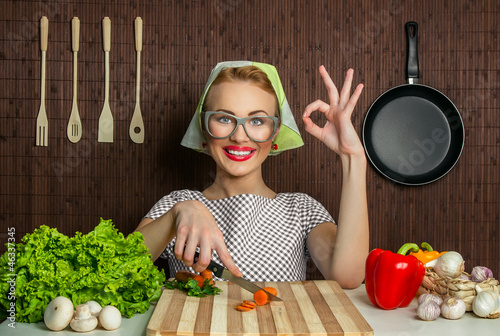 Photo: Happy woman cook with okay sign cut carrot-vintage concept Happy woman cook with okay sign cut carrot-vintage concept
