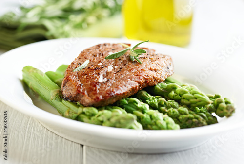 Photo: Beef steak on steamed green asparagus Beef steak on steamed green asparagus