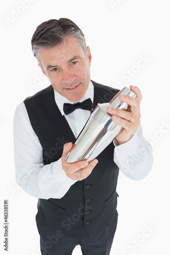 Photo: Waiter shaking drink in cocktail shaker Waiter shaking drink in cocktail shaker