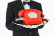 Photo: Red dial phone on a silver tray Red dial phone on a silver tray