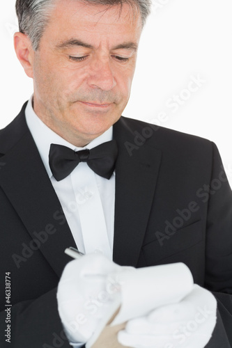 Photo: Waiter writing into his notebook Waiter writing into his notebook
