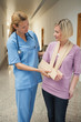 Nurse touching  broken arm of patient
