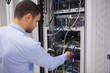 Photo: Man adjusting servers Man adjusting servers