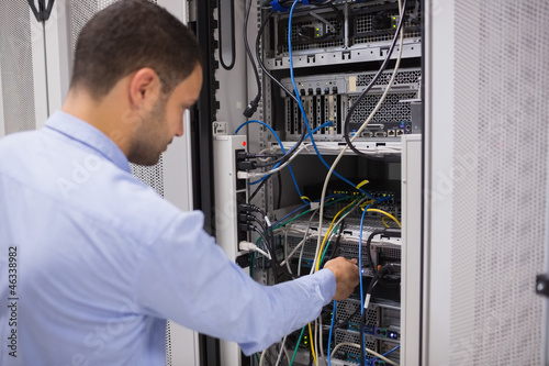 Photo: Man adjusting servers Man adjusting servers