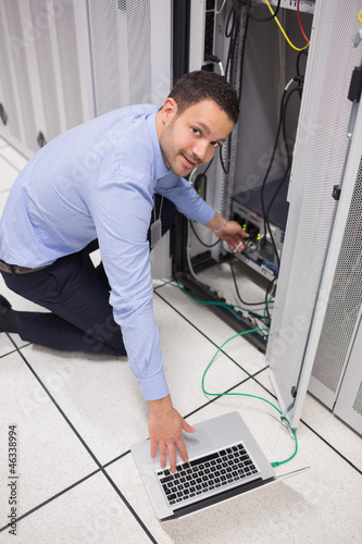 Photo: Smiling technician inserting a USB Smiling technician inserting a USB