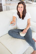 Photo: Woman watching tv and eating popcorn Woman watching tv and eating popcorn