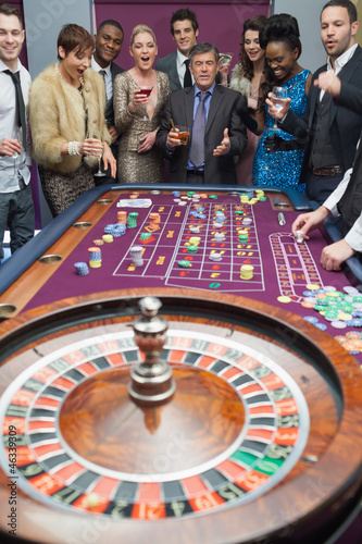 Photo: People standing at the roulette table People standing at the roulette table