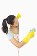 Laughing woman who washes plate form the side