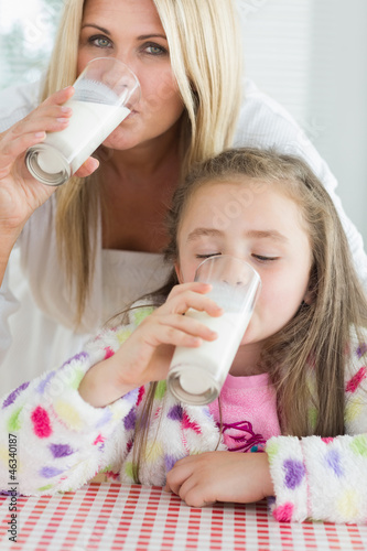 Photo: Mother and little girl drinking milk Mother and little girl drinking milk