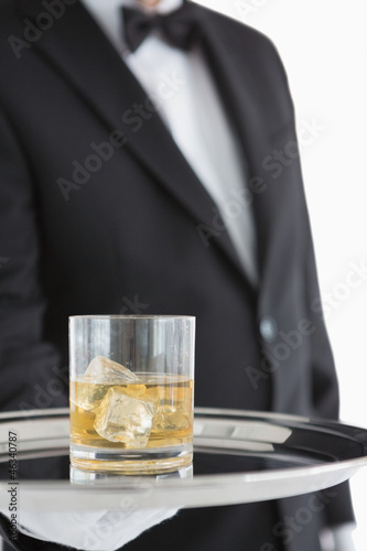Photo: Man holding tray with whiskey Man holding tray with whiskey