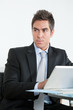 Young Businessman Using Digital Tablet In Office