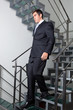 Businessman Walking Down The Stairs
