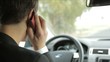 Handsome man driving car and talking on the phone