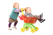 Photo: Toddler girl pushing her twin brother in a toy cart Toddler girl pushing her twin brother in a toy cart