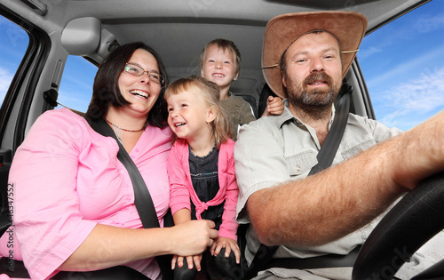 Photo: Happy family together traveling in the car. Happy family together traveling in the car.