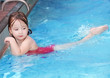 Happy child bathing in a swimming pool.