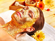 Woman getting  facial mask .
