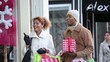 Couple in warm clothing Christmas shopping on urban street