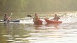 Caucasian family in kayaks on river