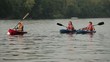 Caucasian family in kayaks on river