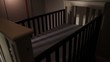 Empty crib in dim nursery