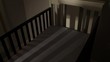 Empty crib in dim nursery