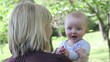 Caucasian mother holding clapping baby