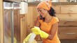 woman talking on the phone while cleaning her kitchen