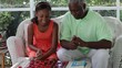Black grandfather and granddaughter playing checkers