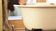 Mixed race woman relaxing in the bathtub