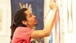 Mixed race artist painting in his studio