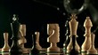 Water splashes down onto chess pieces on chess board (slow motion)