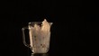 Fruit and milk flying out of blender (slow motion)