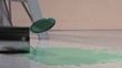 Paint can lid falling into pool of paint (slow motion)