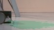 Paint can lid rolling through pool of paint (slow motion)
