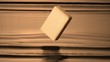 Bar of soap dropping into body of water (slow motion)