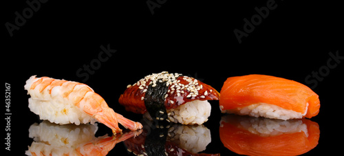 Photo: delicious sushi isolated on black delicious sushi isolated on black