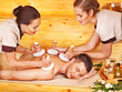 Man getting herbal ball massage treatments .