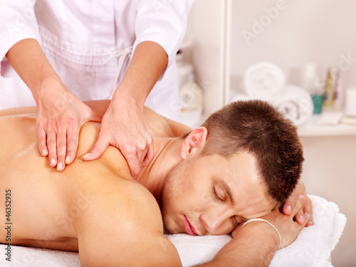 Photo: Man getting massage in spa. Man getting massage in spa.