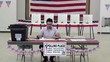Video: Hispanic registrar sitting at table in a community center polling place for voters Hispanic registrar sitting at table in a community center polling place for voters