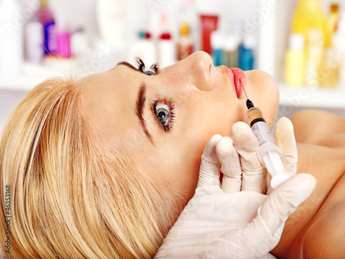 Photo: Woman giving botox injections. Woman giving botox injections.