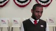 Video: Hispanic man in front of voting booths putting on "i voted" sticker and giving thumbs up Hispanic man in front of voting booths putting on "i voted" sticker and giving thumbs up
