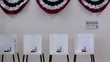 Clip of interior of polling place with row of voting booths